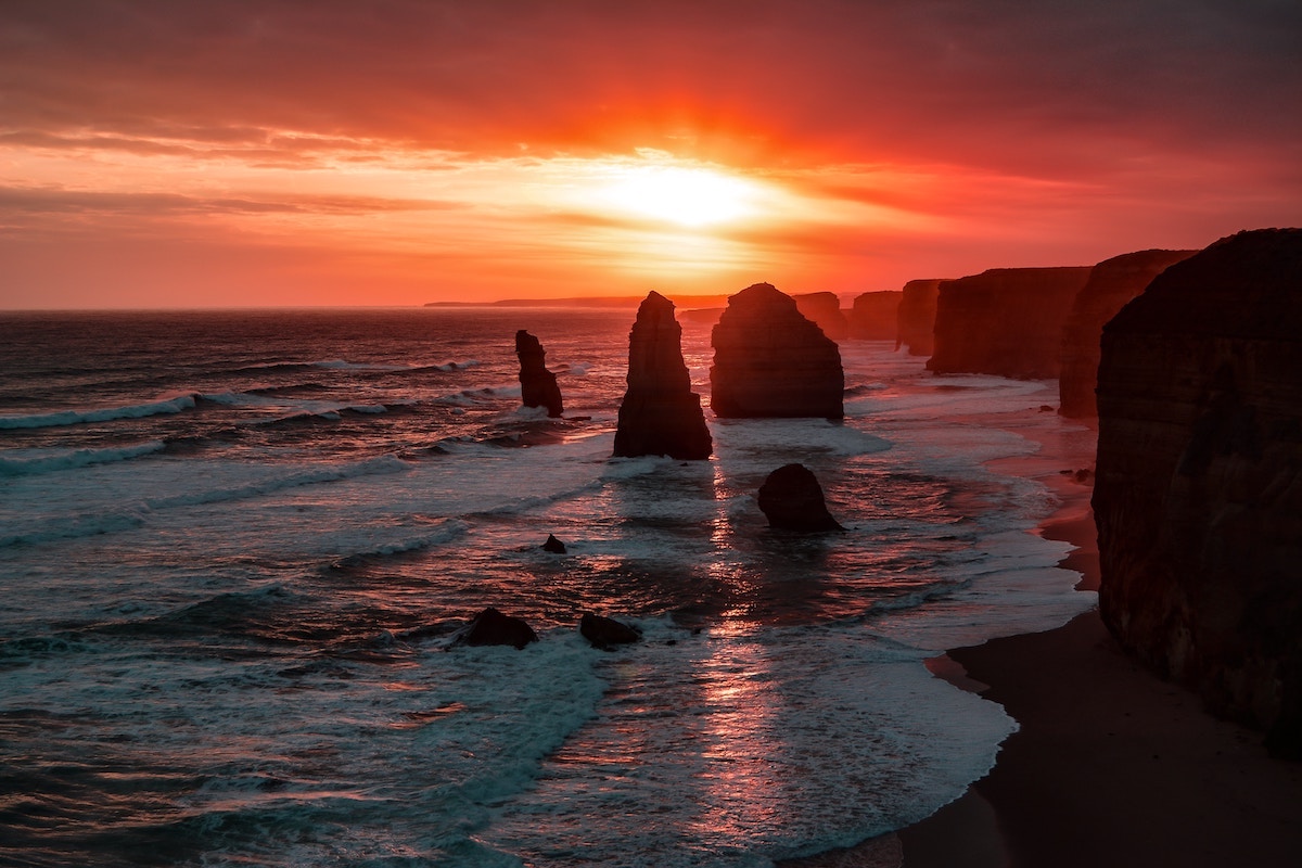 sunset behind stone spires on a beach in Australia