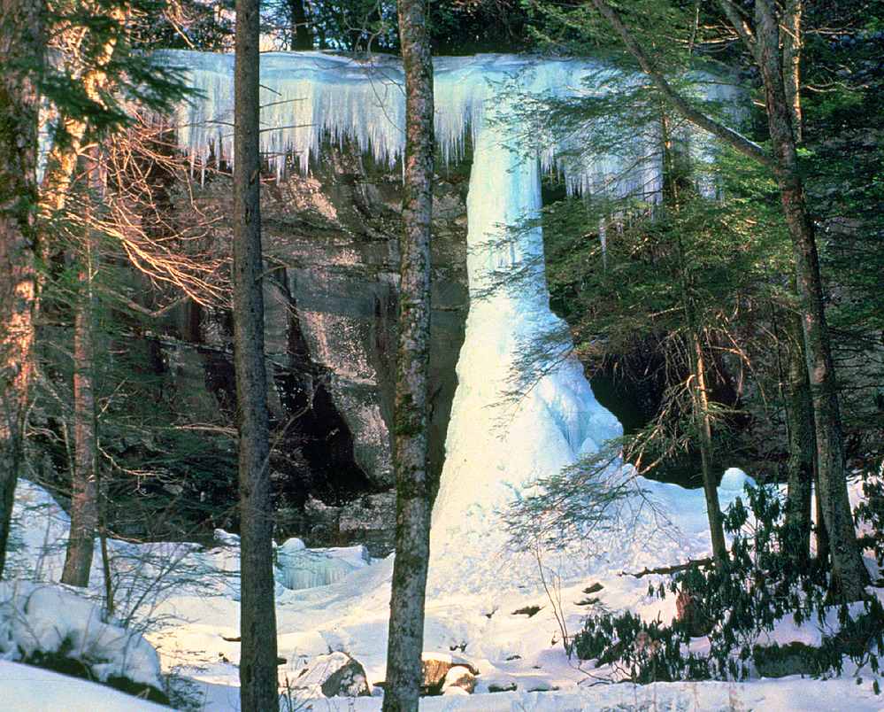 A frozen waterfall creates an ice column in the forest of Smoky Mountain National Park. 