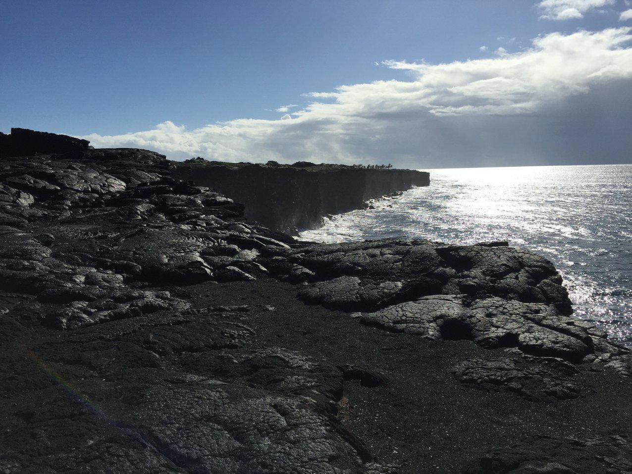 Black rocks along the ocean coast line view of Hawai'i Volcanoes National Park. 