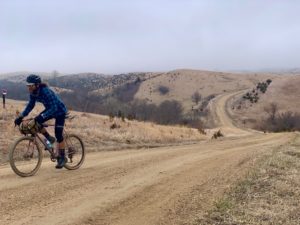 Professional endurance athlete Anton Krupicka trains on his gravel bike along a dirt road.