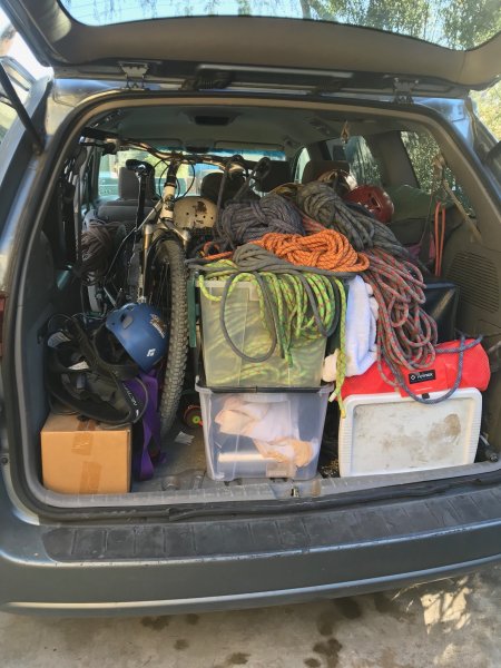 An open hatchback on a sport utility vehicle showing ropes and rescue gear inside.