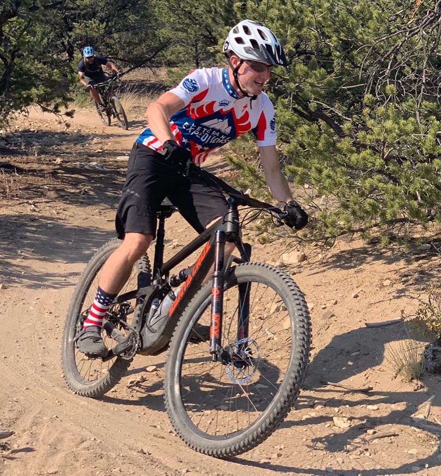 a man mountain biking on a trail.