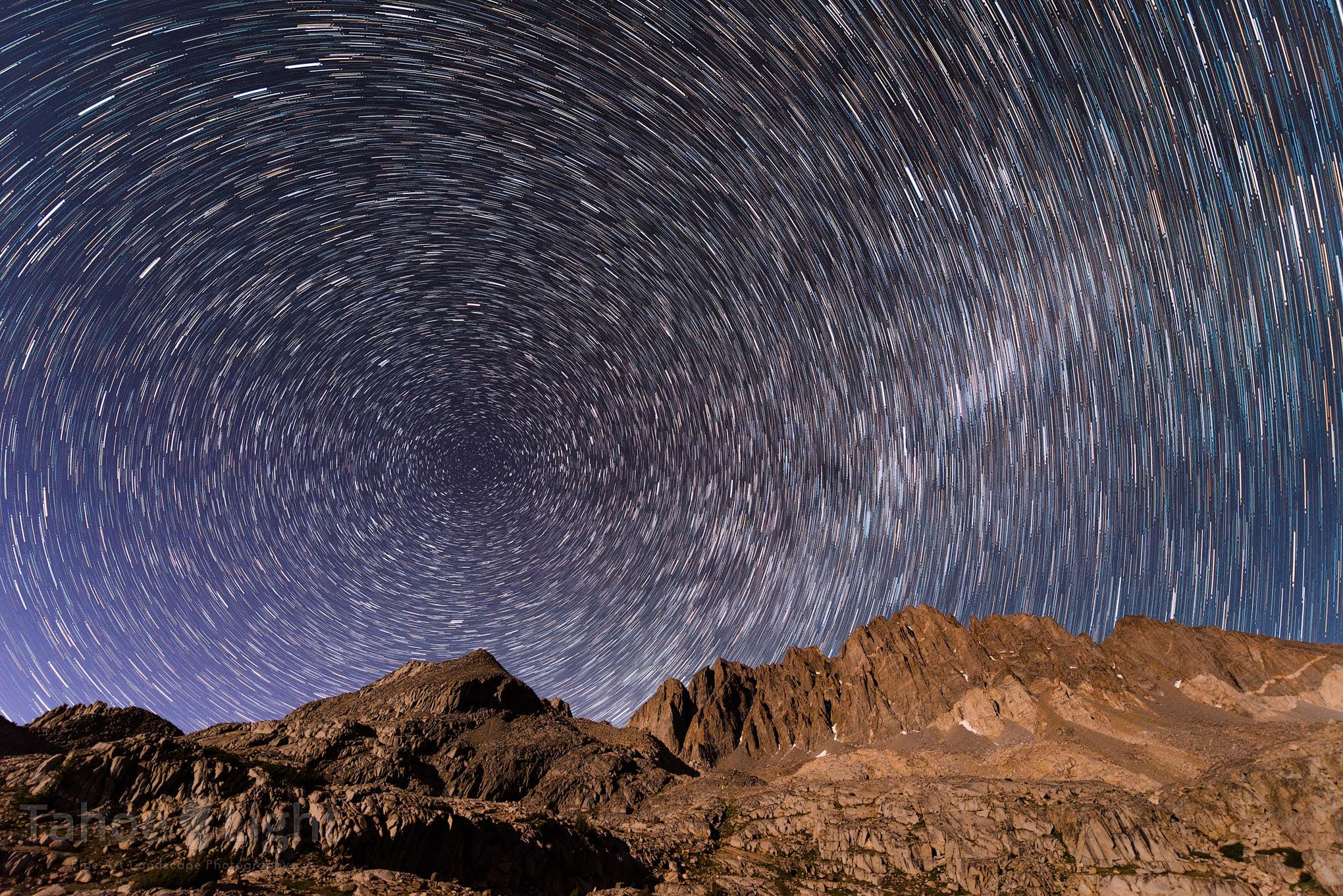 Star trails through the night sky over rocky Mount Whitney
