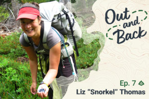 The Out and Back Podcast logo is overlaid on a photo of Liz "Snorkel" Thomas carrying a heavy backpack. She reaches out a hand filled with blueberries. Text saying "Liz 'Snorkel' Thomas sits on the bottom of the image.