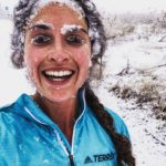 Abby smiles through a face caked in snow and ice.