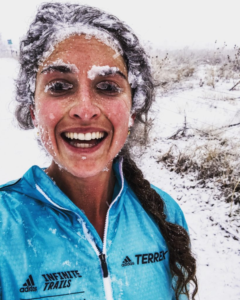 Abby smiles through a face caked in snow and ice.