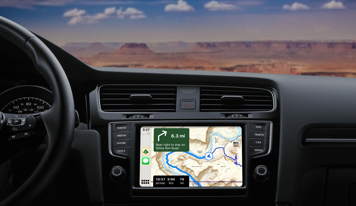 A car dashboard with Gaia GPS on Apple CarPlay shows turn-by-turn directions.