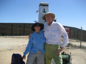 Barney and Scout stand with their arms around each other's shoulders at the pole signifying the southern terminus of the PCT.