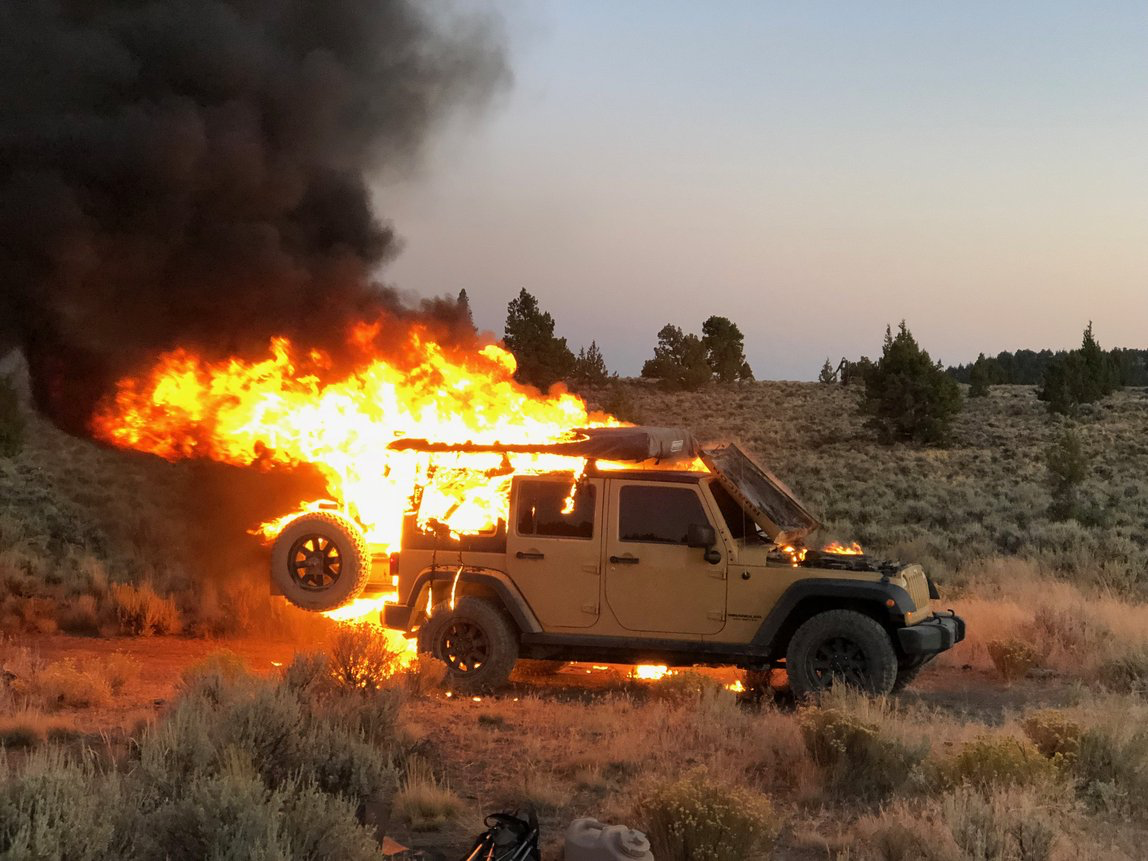 Jeep on fire in the desert.