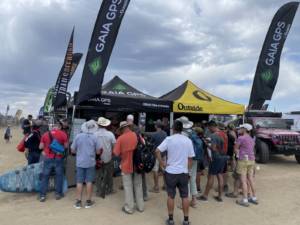 people crowd around Gaia GPS's booth at Overland Expo Mountain West